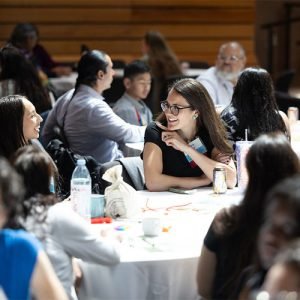 people talking around a table during a conference