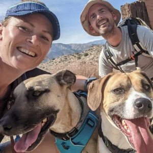 Faye, her partner, Jeff, and her dogs, Callie and Hank, on a hike