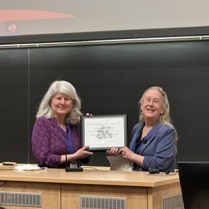 Lisa Harnack and another woman holding an award plaque