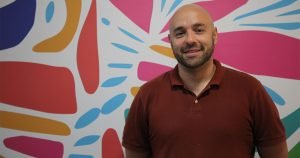 Rodrigo Andres Stein Morales standing in front of a colorful wall