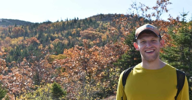 Nicholas Rethemeier smiling while hiking